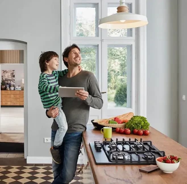 Father and son in kitchen looking at the light