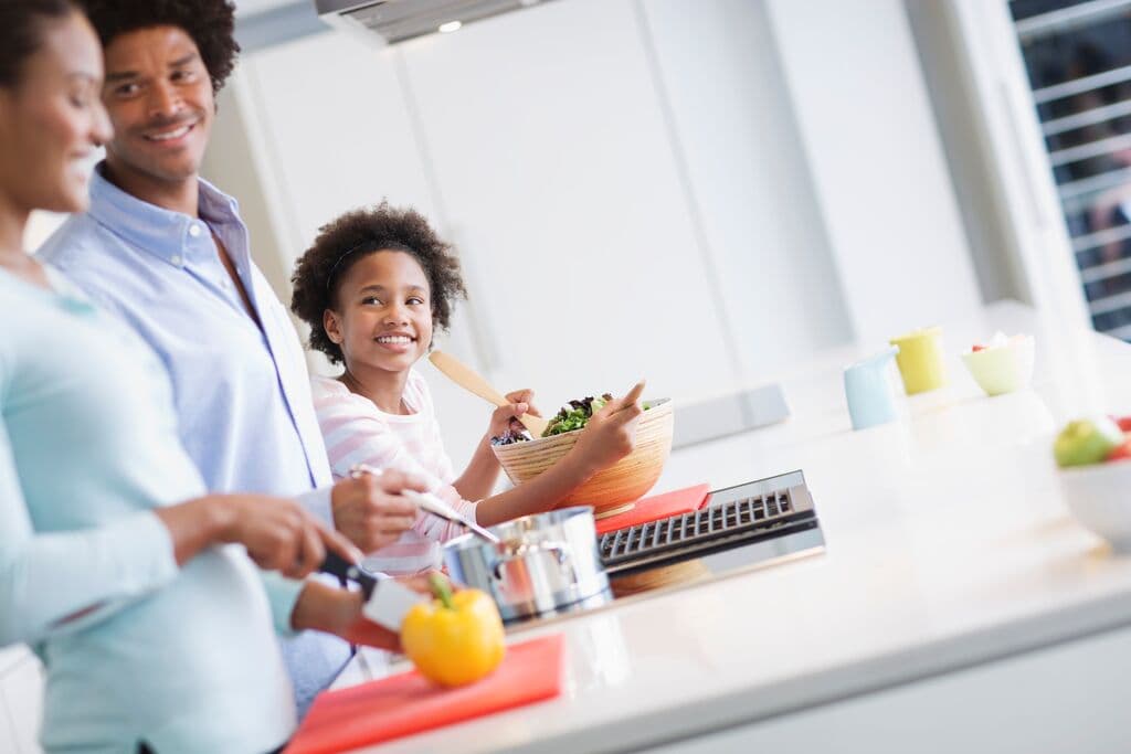 Family preparing a meal together in kitchen