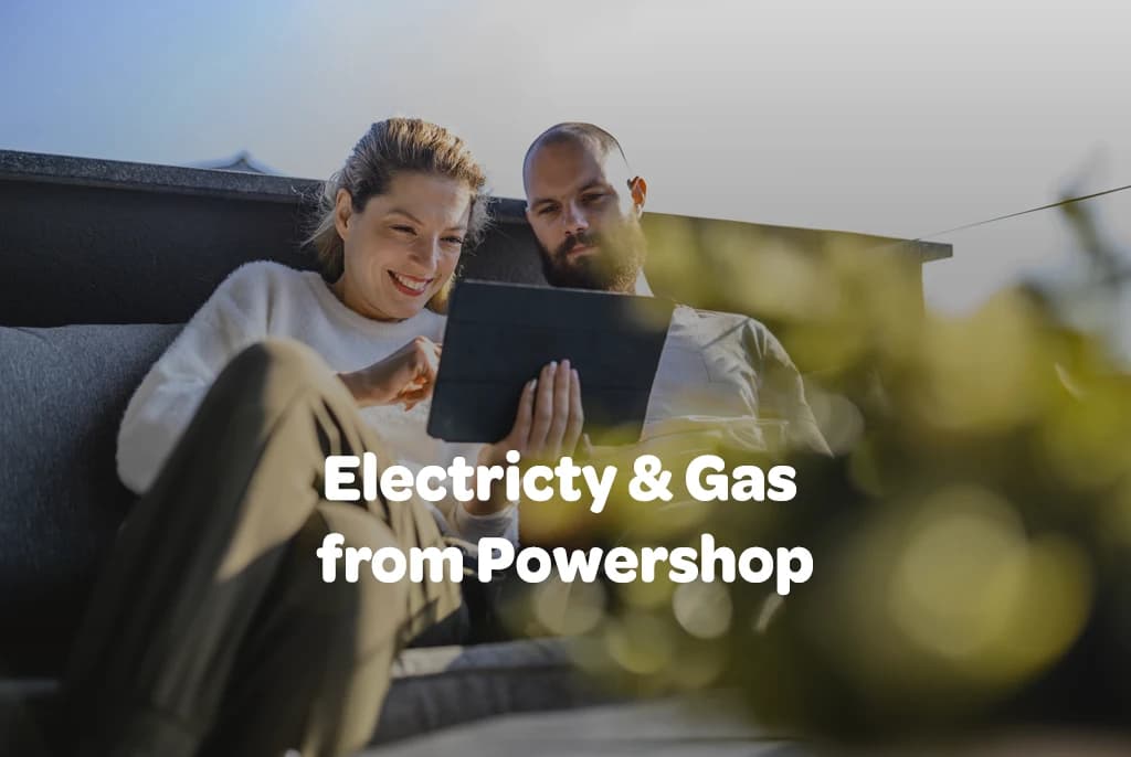 Couple sitting outdoors looking at tablet, with text:
Electricity & Gas from Powershop